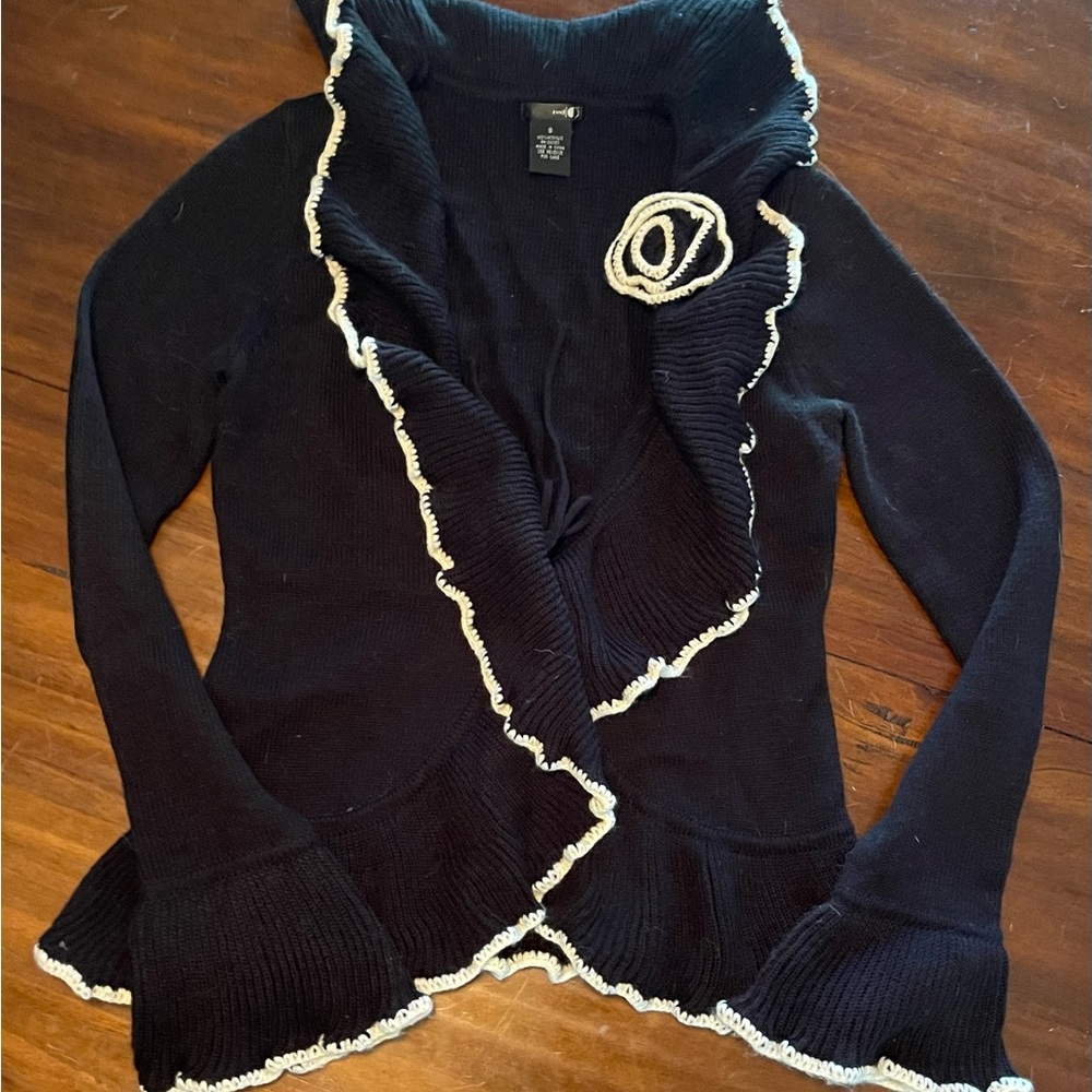 Black and white knitted sweater with flower on shoulder